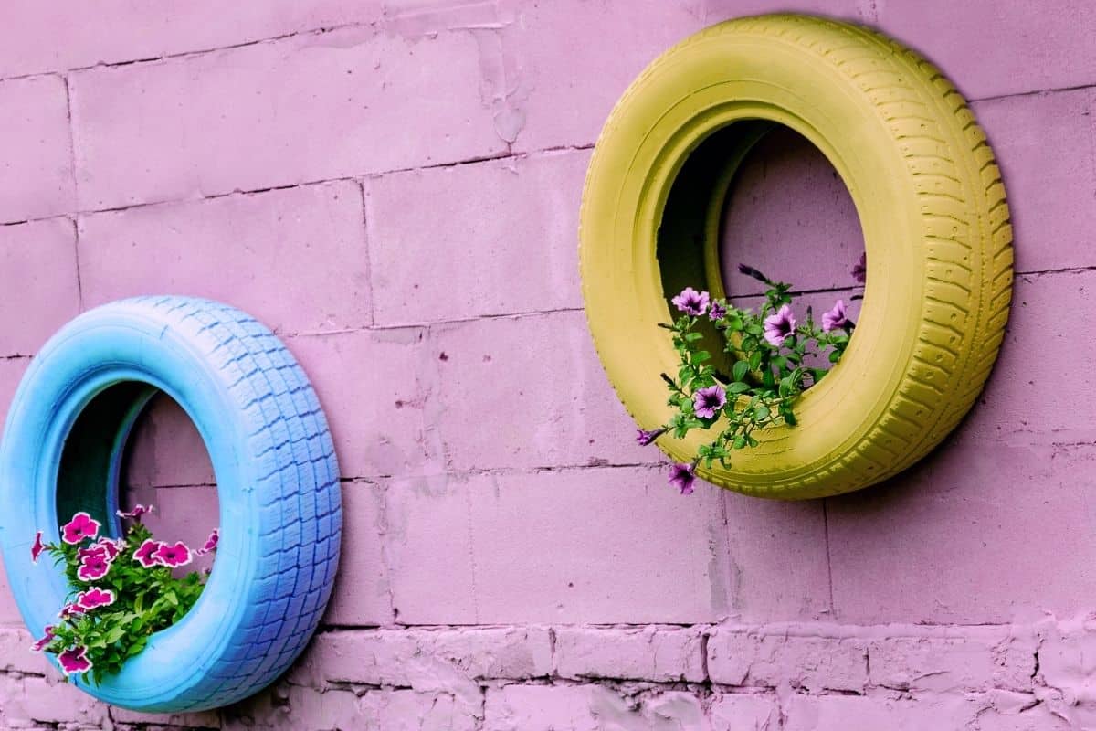 colorful tire planters hanging on a wall