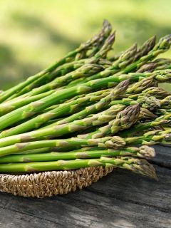 a bunch of fresh asparagus in a basket