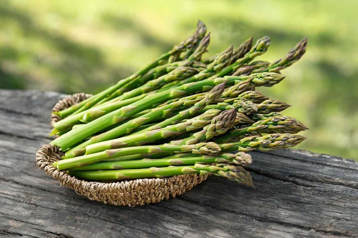 a bunch of fresh asparagus in a basket 