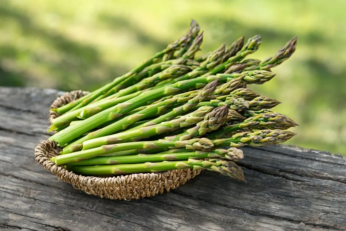 a bunch of fresh asparagus in a basket 