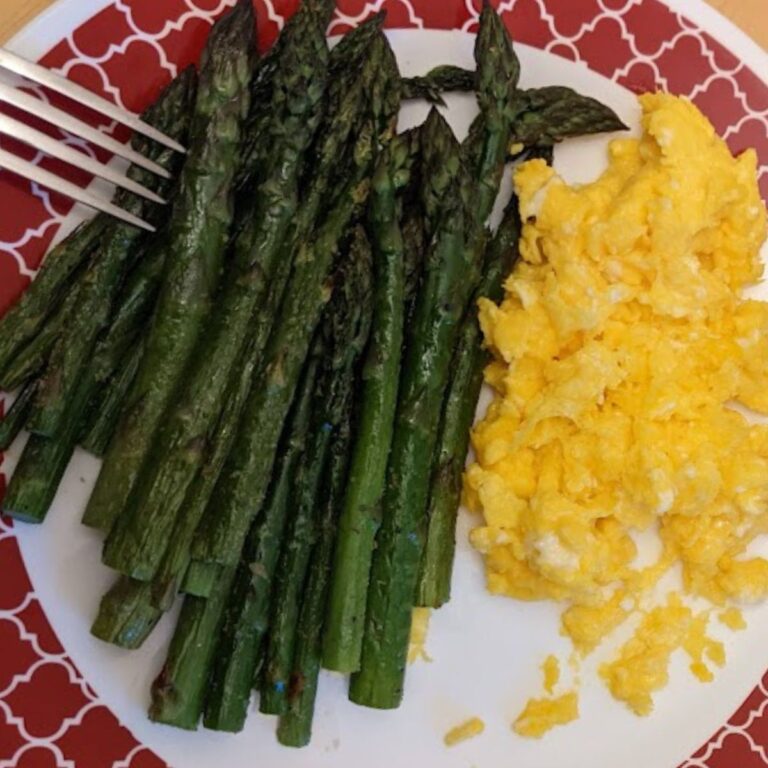 A plate of broiled asparagus and omelet.