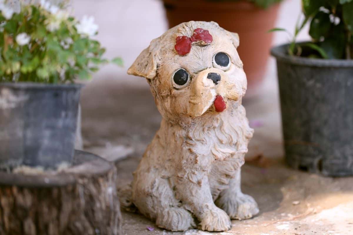 cute puppy statue with a red bow