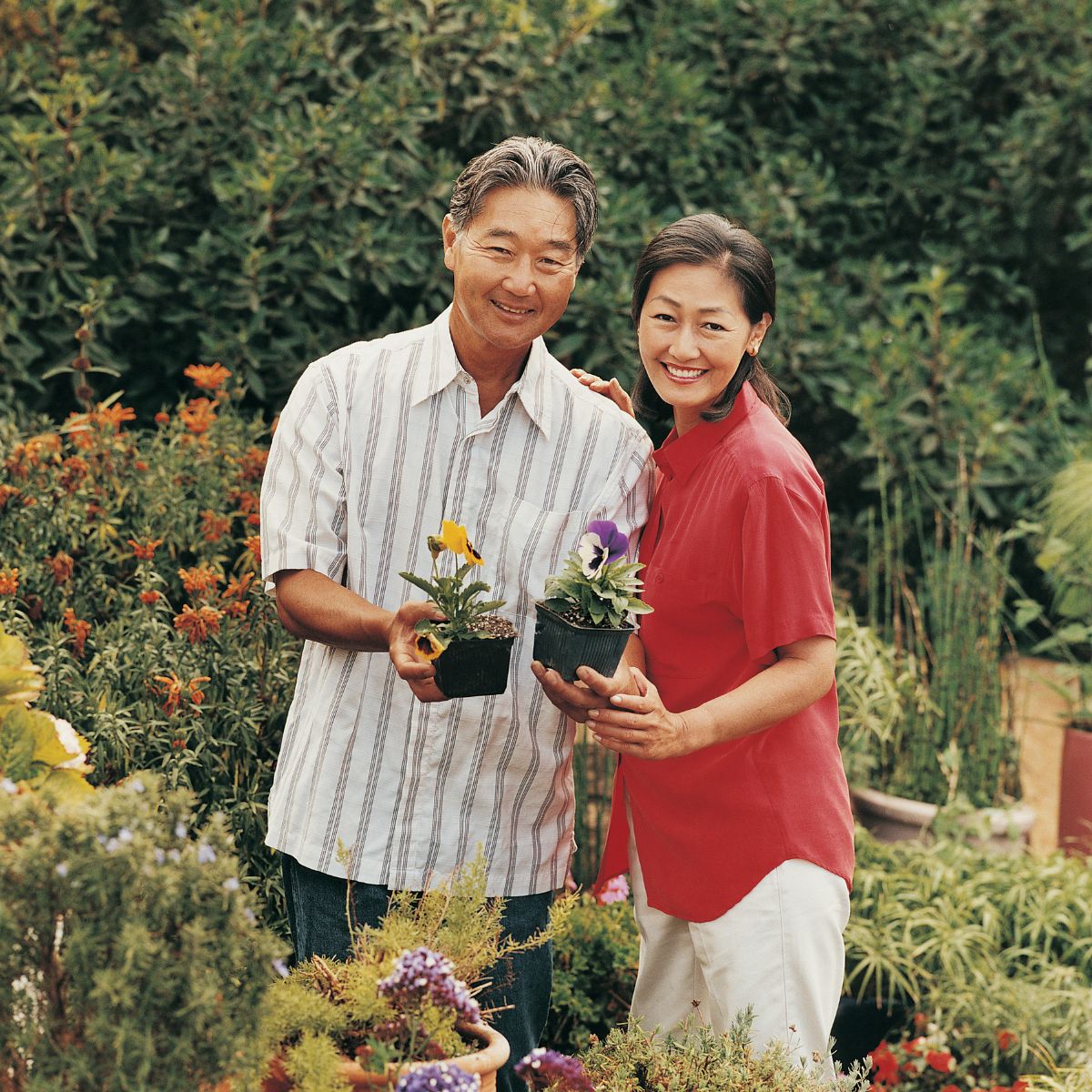 father and daughter planting flowers in the garden