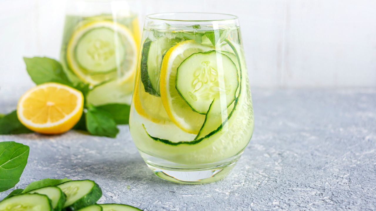 Fresh cool detox water drink with cucumber and lemon. glass of Lemonade with basil and mint leaves. Concept of proper nutrition and healthy eating. Fitness diet. Copy space for text