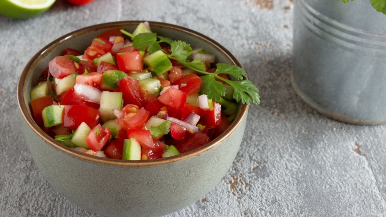 Pico de Gallo salsa in a bowl. Traditional Mexican cuisine dish with tomato, cucumber, onion and fresh coriander.