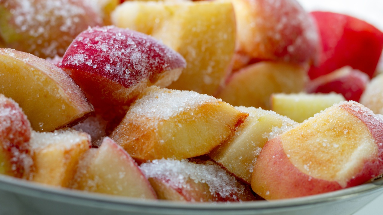 Pieces of apple from refrigerator with sugar.