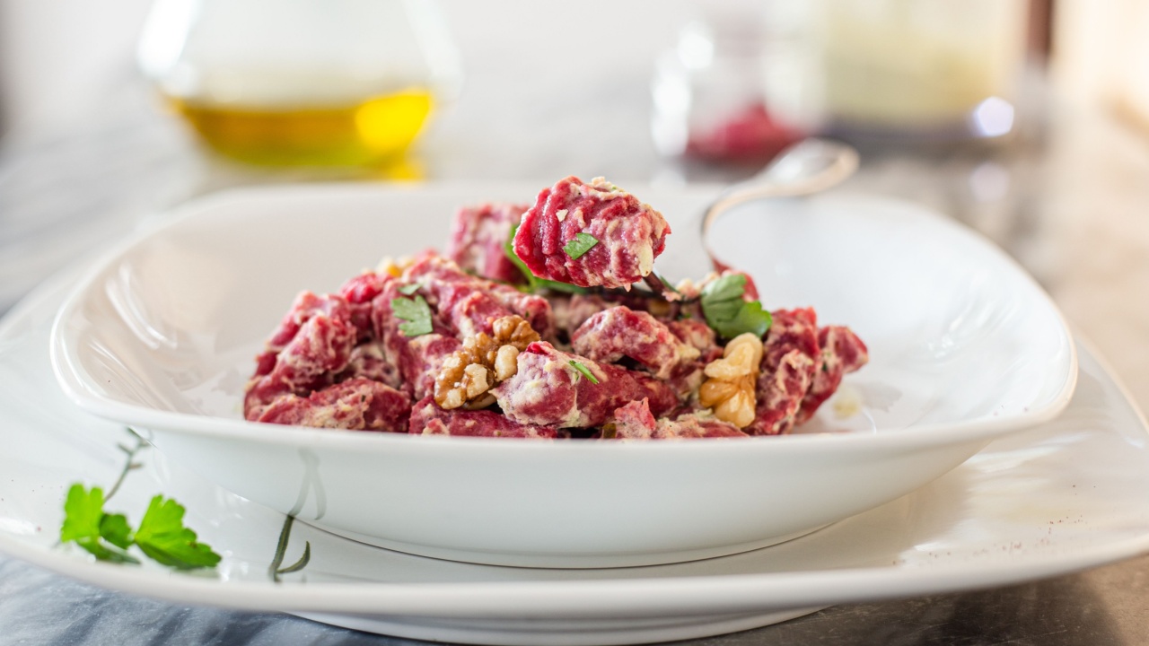 Pink colored Beetroot Gnocchi on a white place. Italian potato dumplings