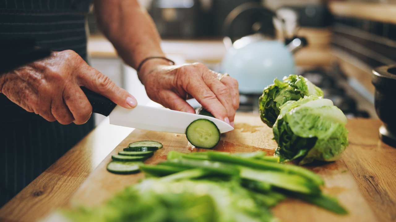 Hands, cutting board and salad in kitchen with green vegetables for healthy food or nutrition. Person with culinary skills for cooking lunch with lettuce, cucumber and organic ingredients at home Hands, cutting board and salad in kitchen with green vegetables for healthy food or nutrition. Person with culinary skills for cooking lunch with lettuce, cucumber and organic ingredients at home