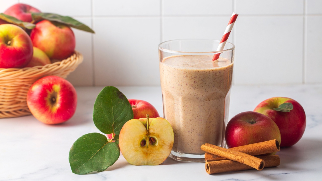 A delicious glass of apple smoothie or apple juice with fresh apple fruits