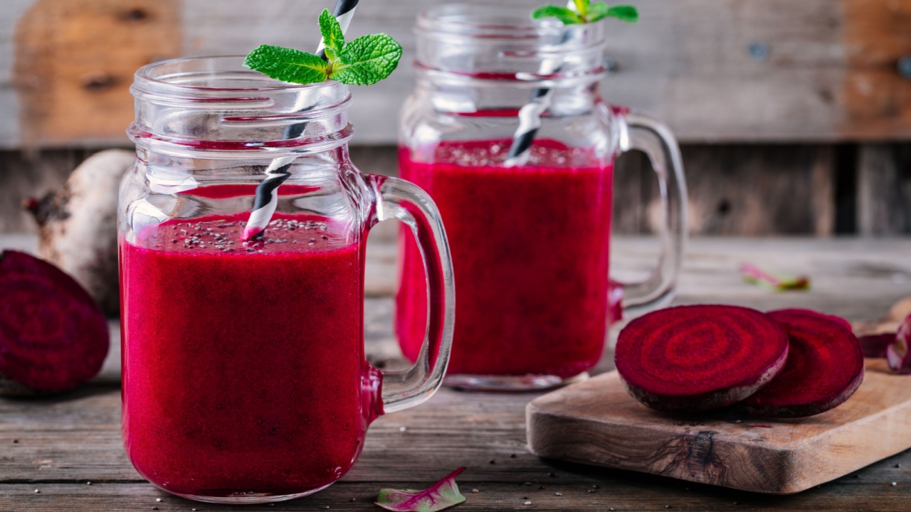 healthy detox beet smoothie with chia seeds in a mason jar on a wooden background