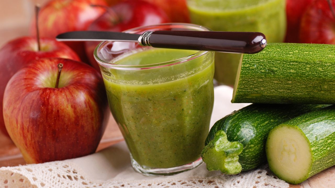 Smoothie apple and zucchini with fresh fruits around