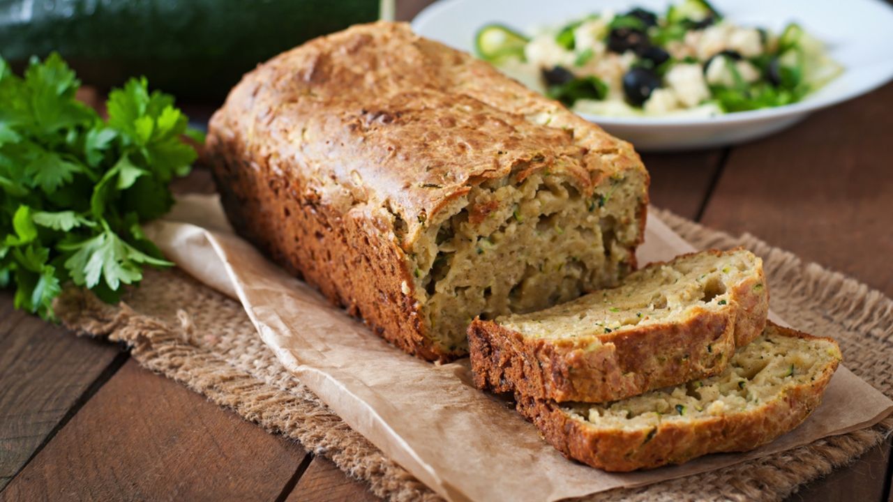 Zucchini bread with cheese on a wooden background