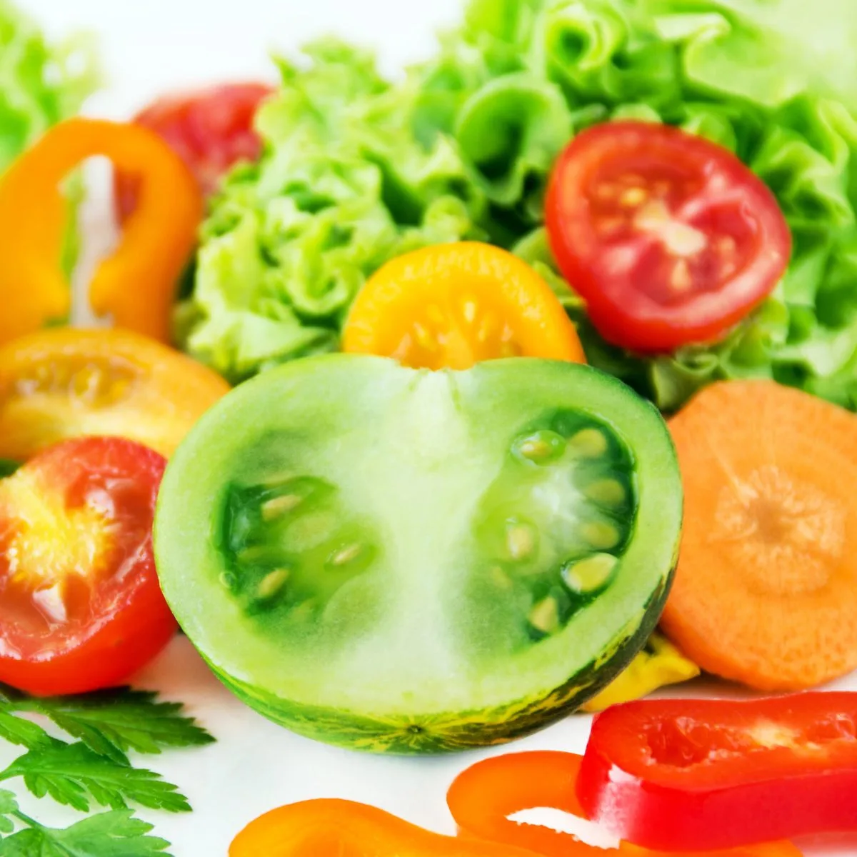 a colorful salad that includes green tomatoes