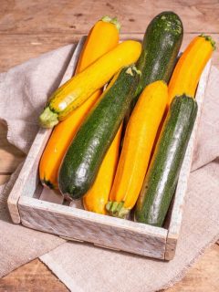 a box of green and yellow zucchini