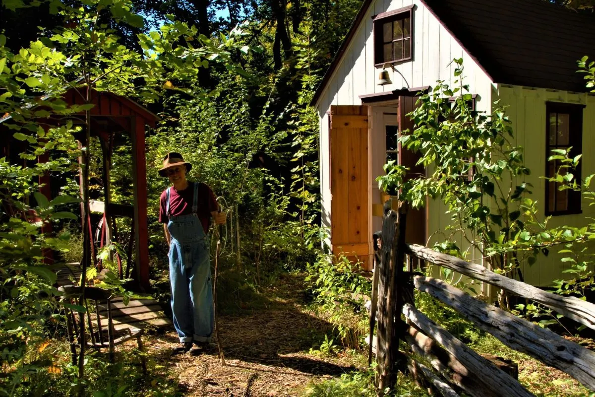 Terry standing in the village, carrying on his mother's legacy