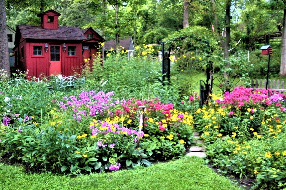 a beautiful garden in fornt of the red cottage library