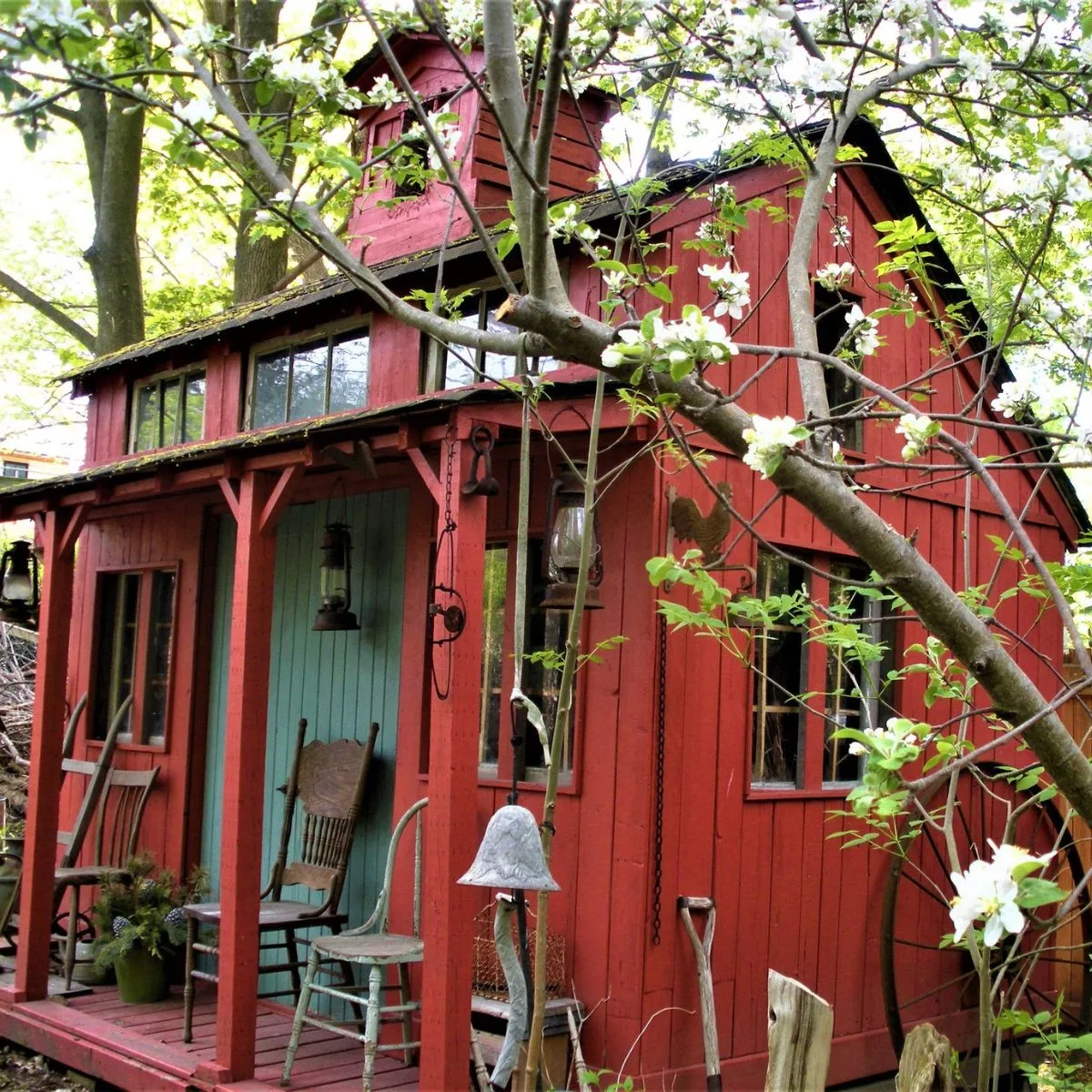 the old mill, a beautiful red building with a cozy sitting area on the porch