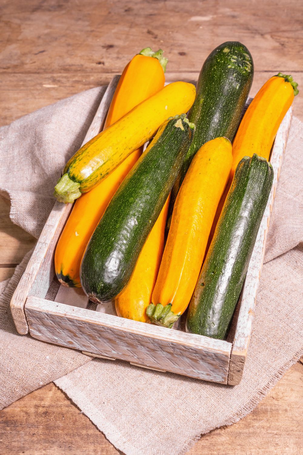 a box of green and yellow zucchini