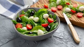 Fresh salad with mozzarella cheese, tomato and spinach. Healthy dieting food.