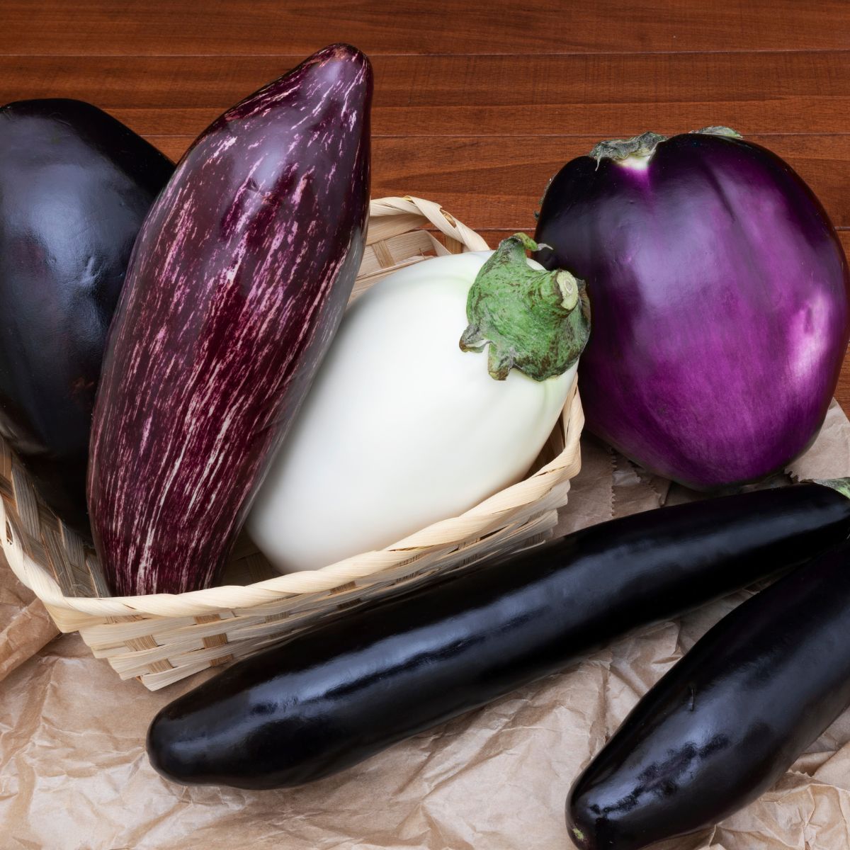 Several varieties of eggplant: long and skinny, white, and striped. 