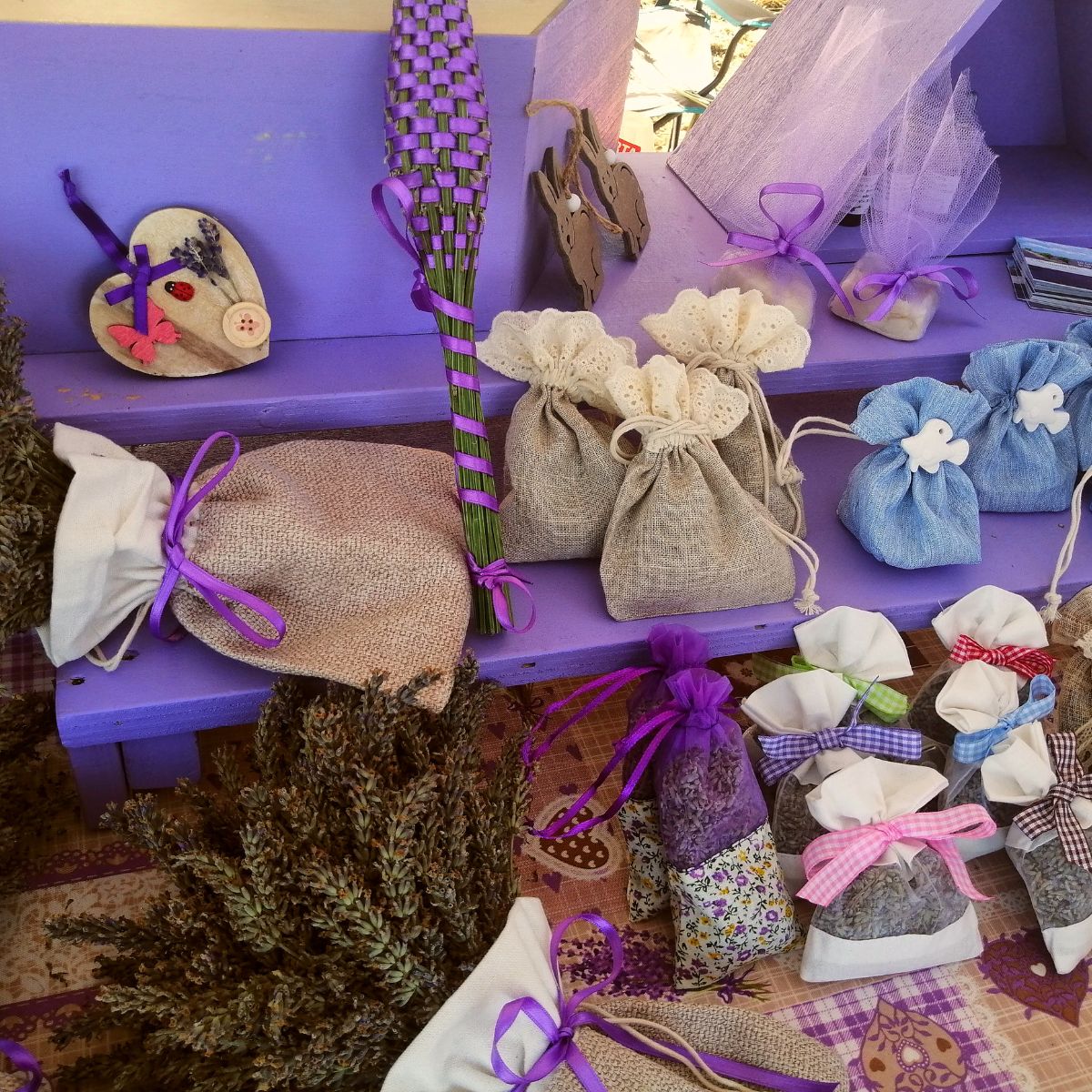 A collection of lavender sachets and other products set up on a table and ready to sell. 