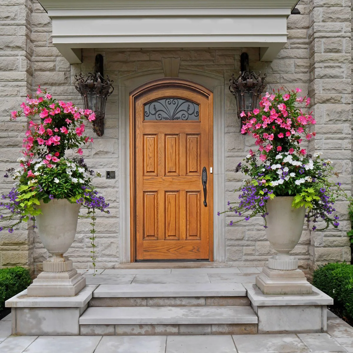 beautiful flower arrangements created in tall concrete planters.