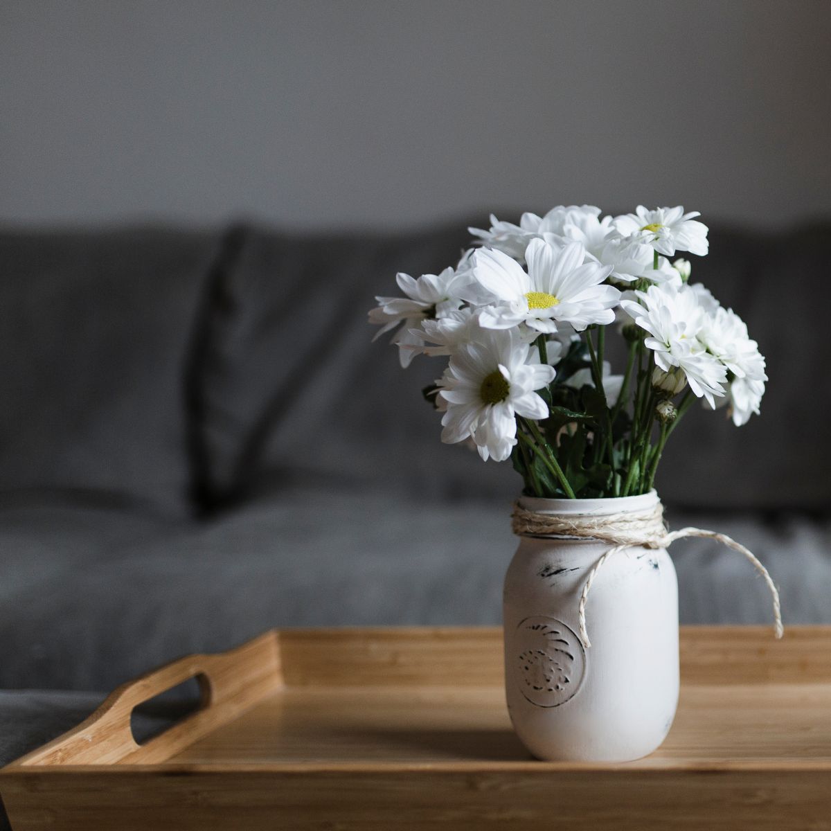 white daisies in a painted mason jar.