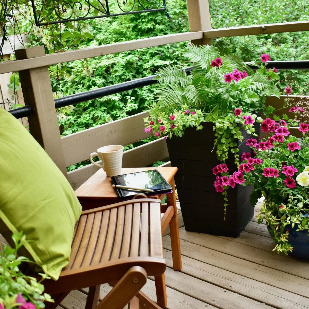 A cozy porch corner filled with brightly colored flowers that provide privacy too.