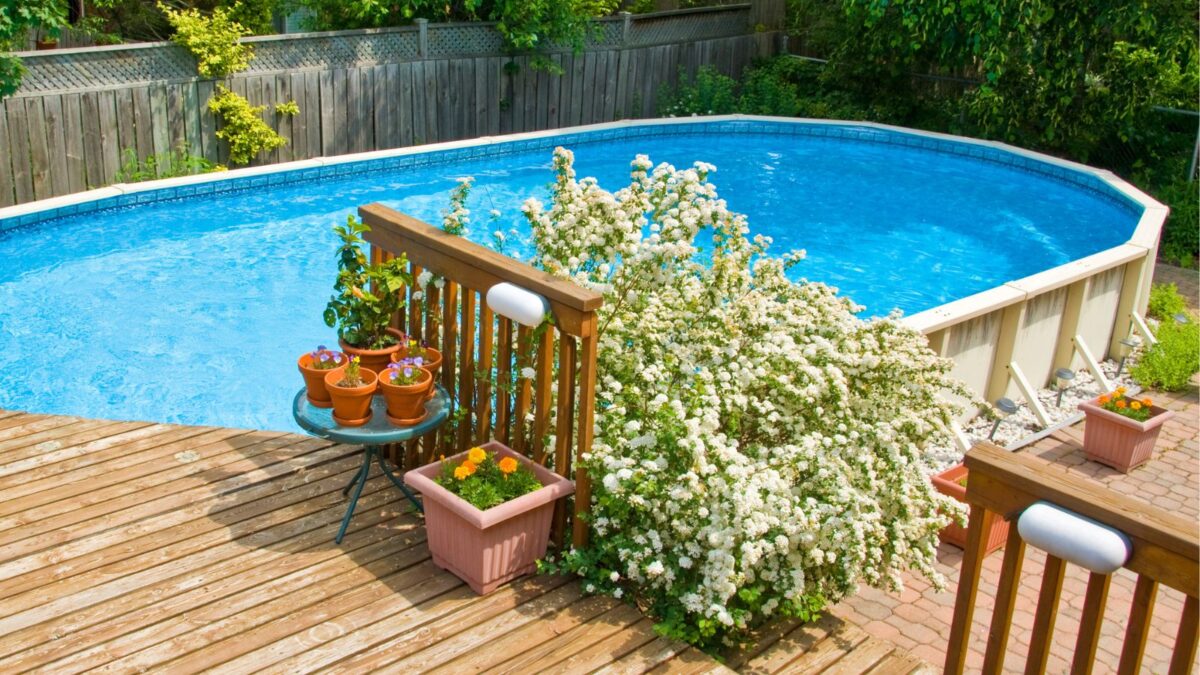 above ground swimming pool with flowers planted nearby.