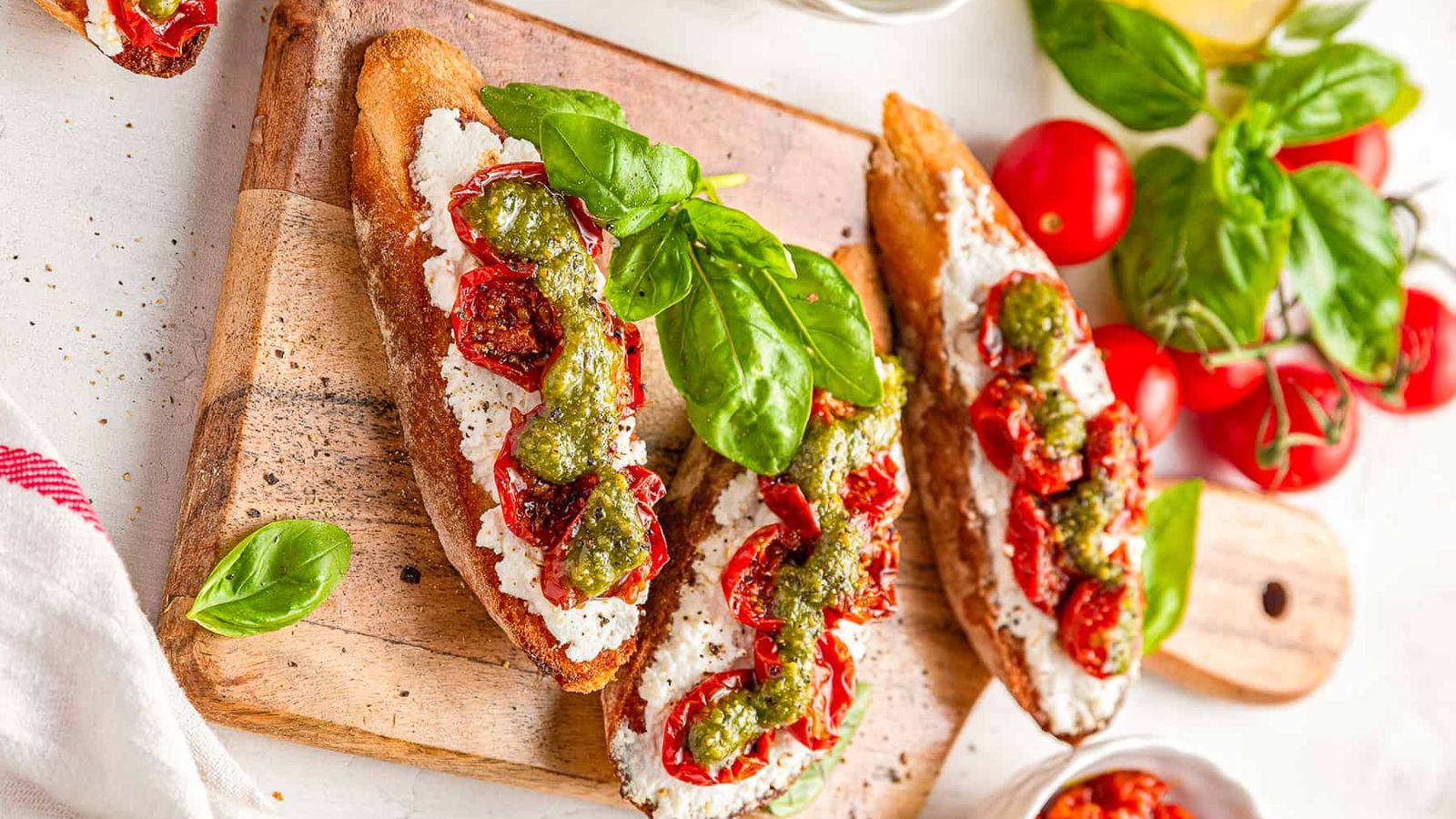 Pesto Ricotta Crostini with Roasted Cherry Tomatoes
