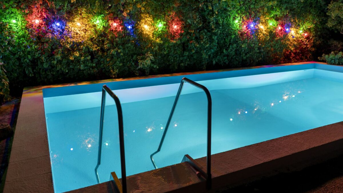colorful lights behind a small pool.