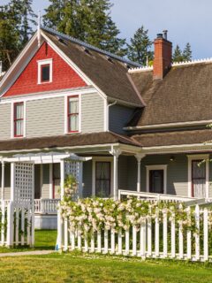 big house with white picket fence.