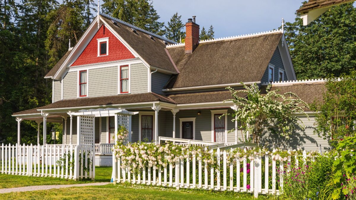 big house with white picket fence. 