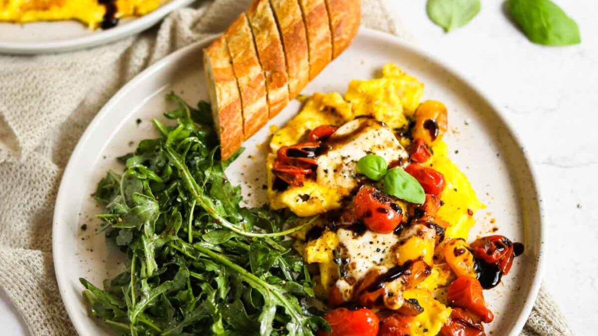 Scrambled Eggs with Cheese, Tomatoes, and Arugula.