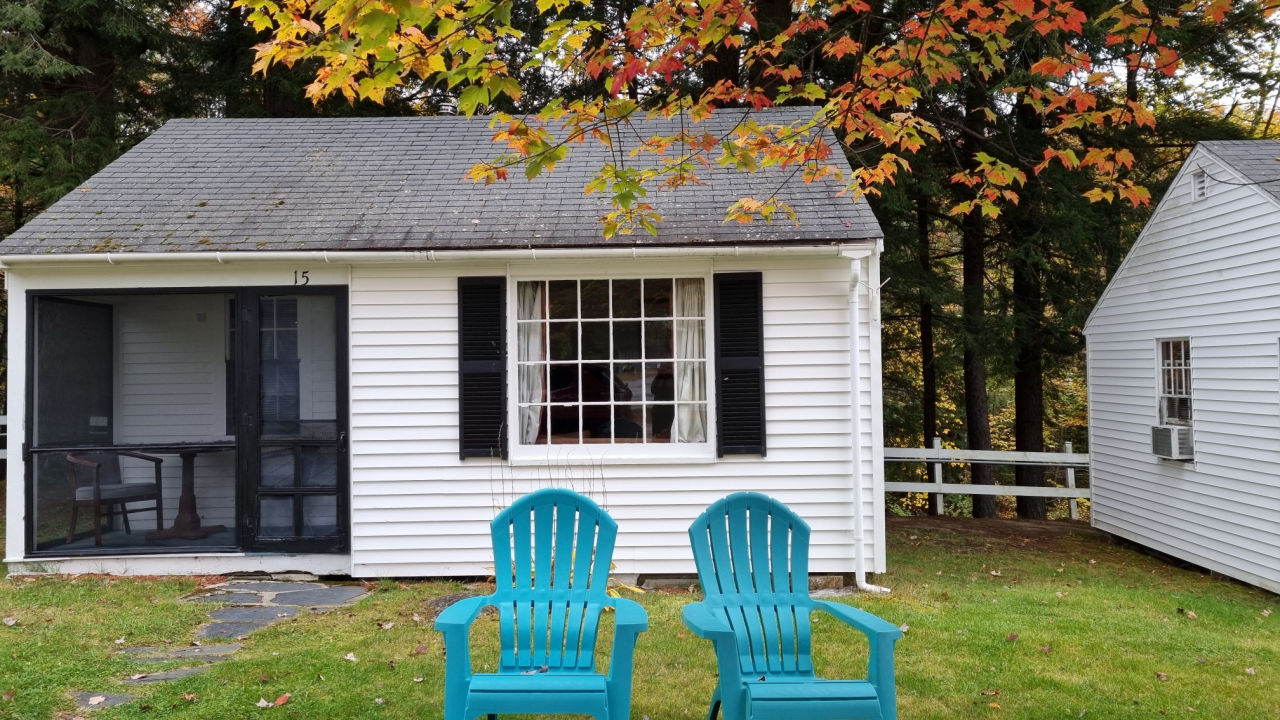 east coast cottage in the fall with blue chairs