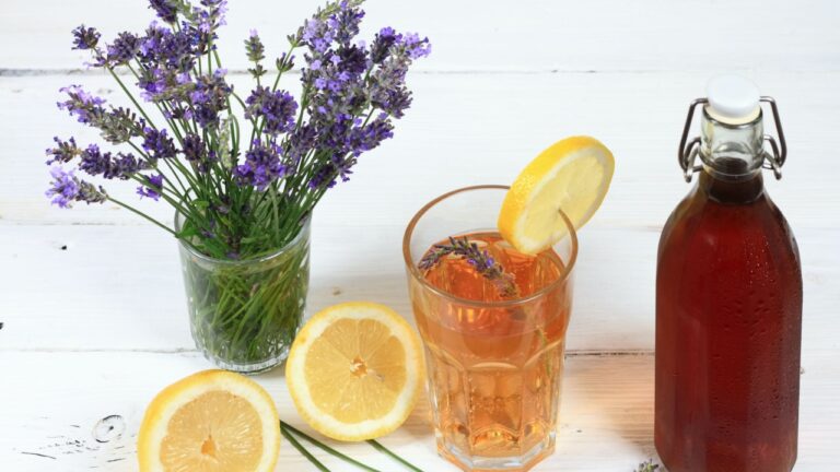 Homemade lavender syrup in a bottle and lemonade. Made from fresh aromatic lavender flowers, sugar or honey and lemon juice