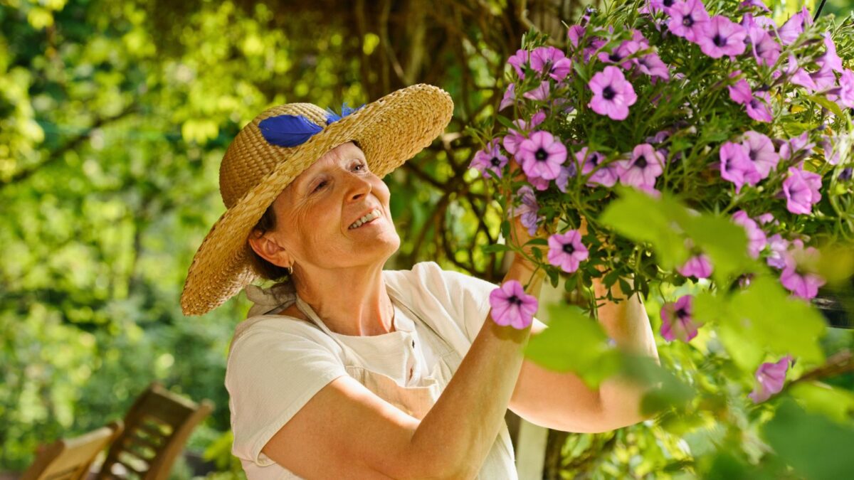 senior woman working on a flower basket.