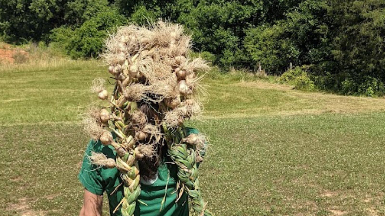 young girl having fun with braided garlic.