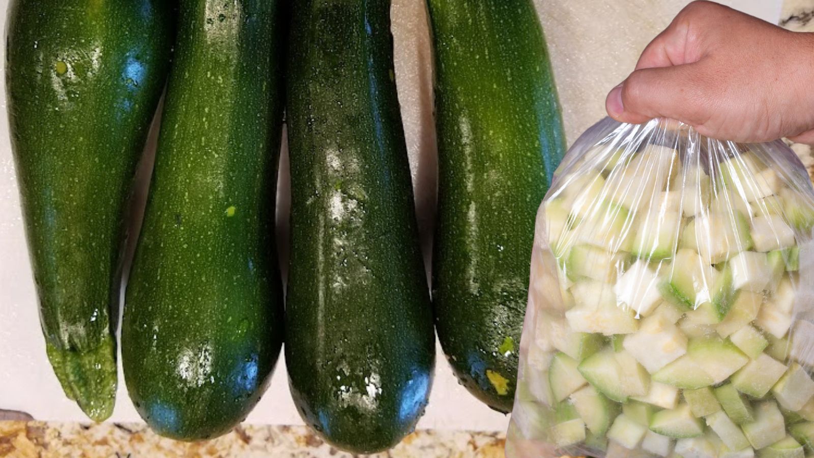 whole zucchini on a white cutting board and cubed zucchini in a bag, ready for freezing.