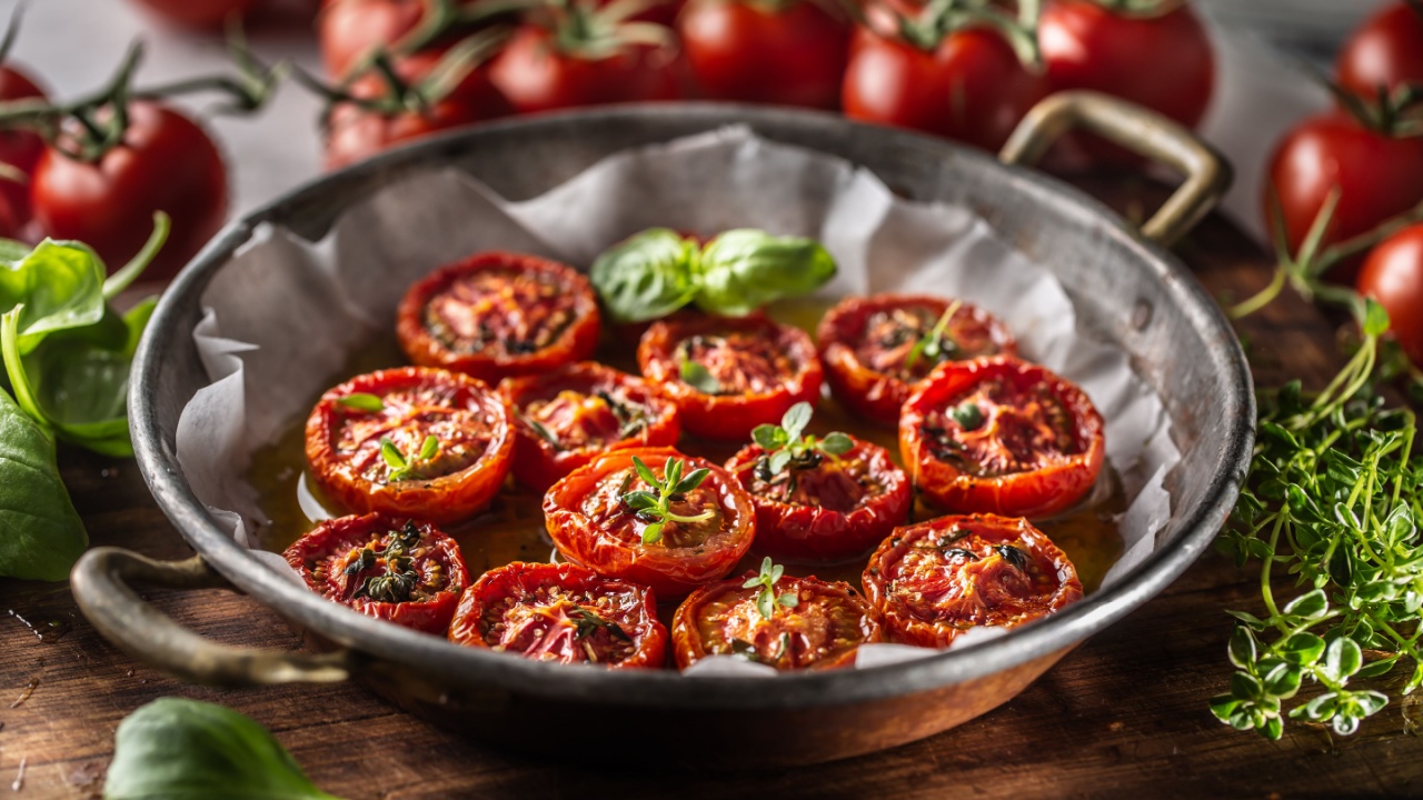 Roasted tomatoes with olive oil thyme oregano and basil in pan. Roasted tomatoes with olive oil thyme oregano and basil in pan.