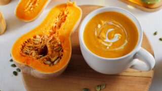 Roasted butternut squash soup with cream and pumpkin seeds.