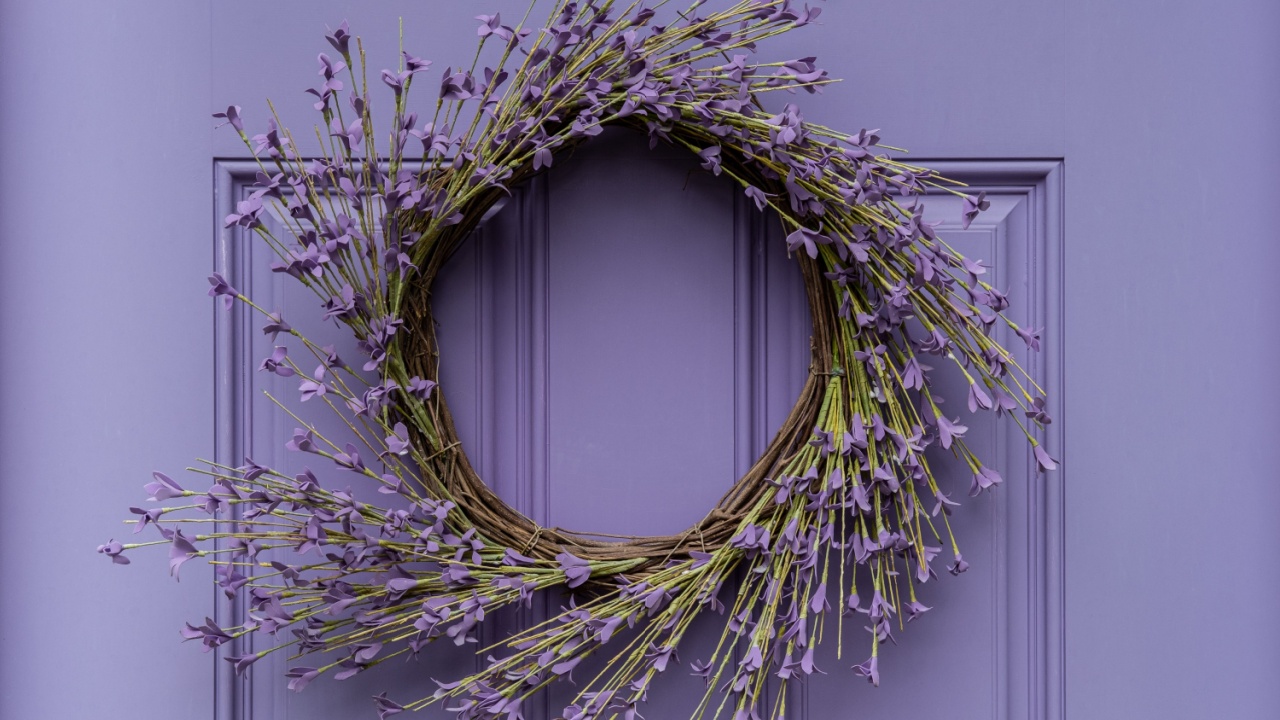 Photograph of a seasonal summer wreath on a lavender colored door
