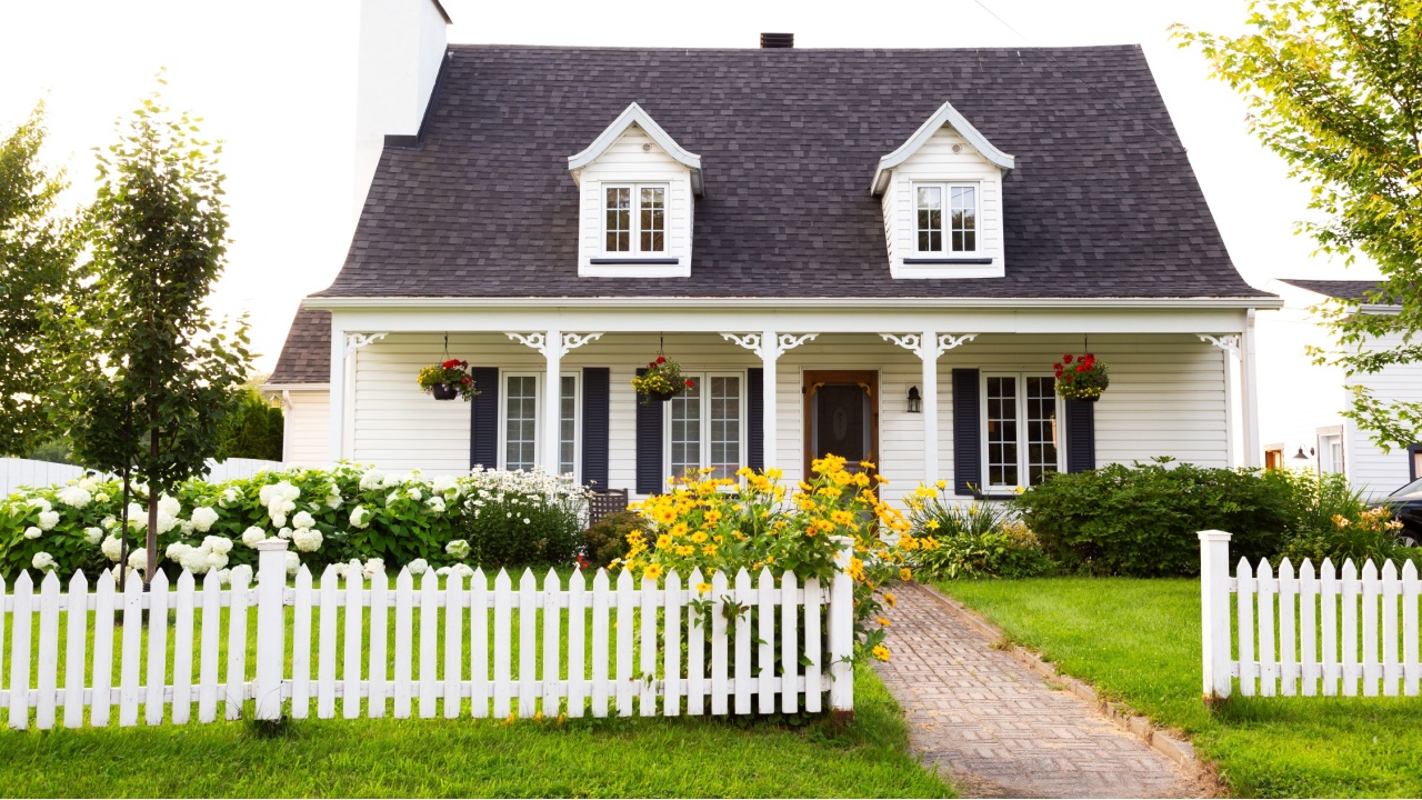 Pretty petite ancestral neoclassical white clapboard house with shingled roof and picket fence in the Ste-Foy area, Quebec City, Quebec, Canada
