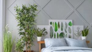 a bedroom with plants by the bed.