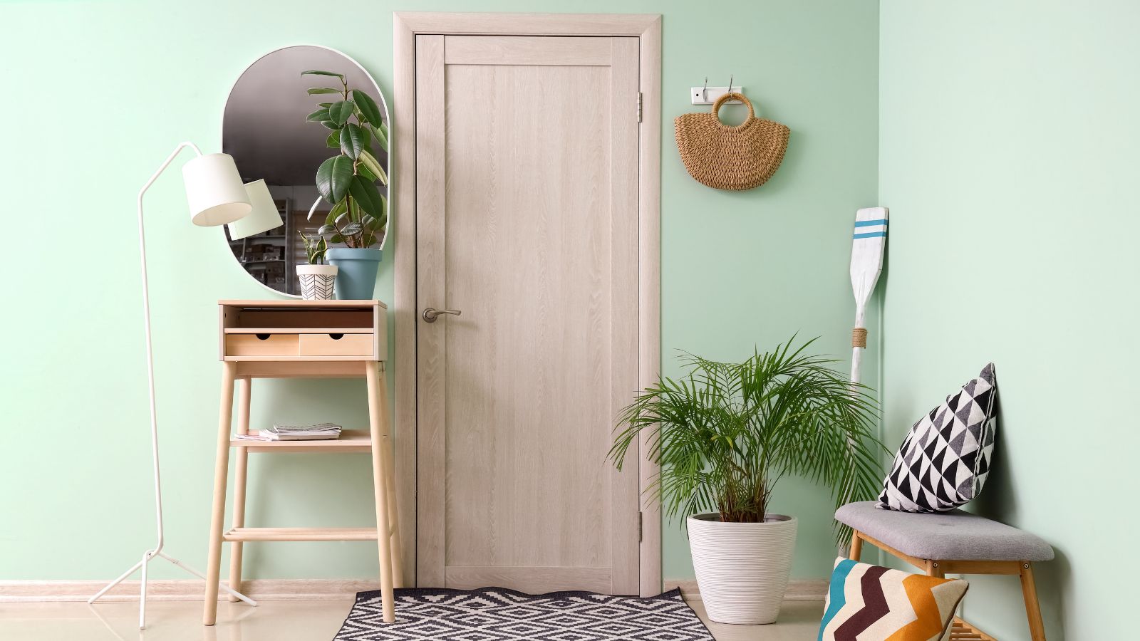 Simple entryway with a bench, table, and a lovely plant.