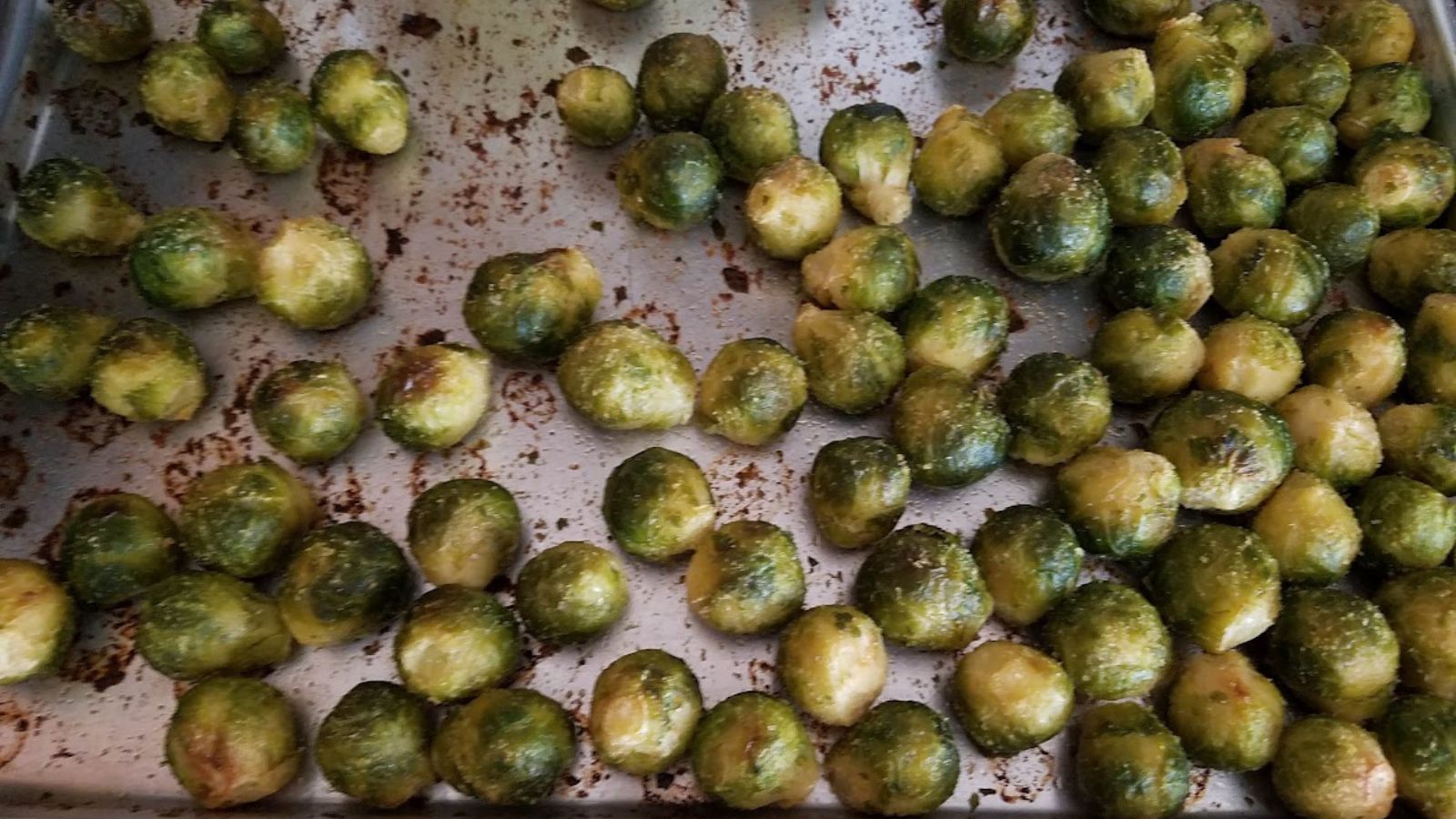 Roasted Brussels sprouts in an aluminum pan.