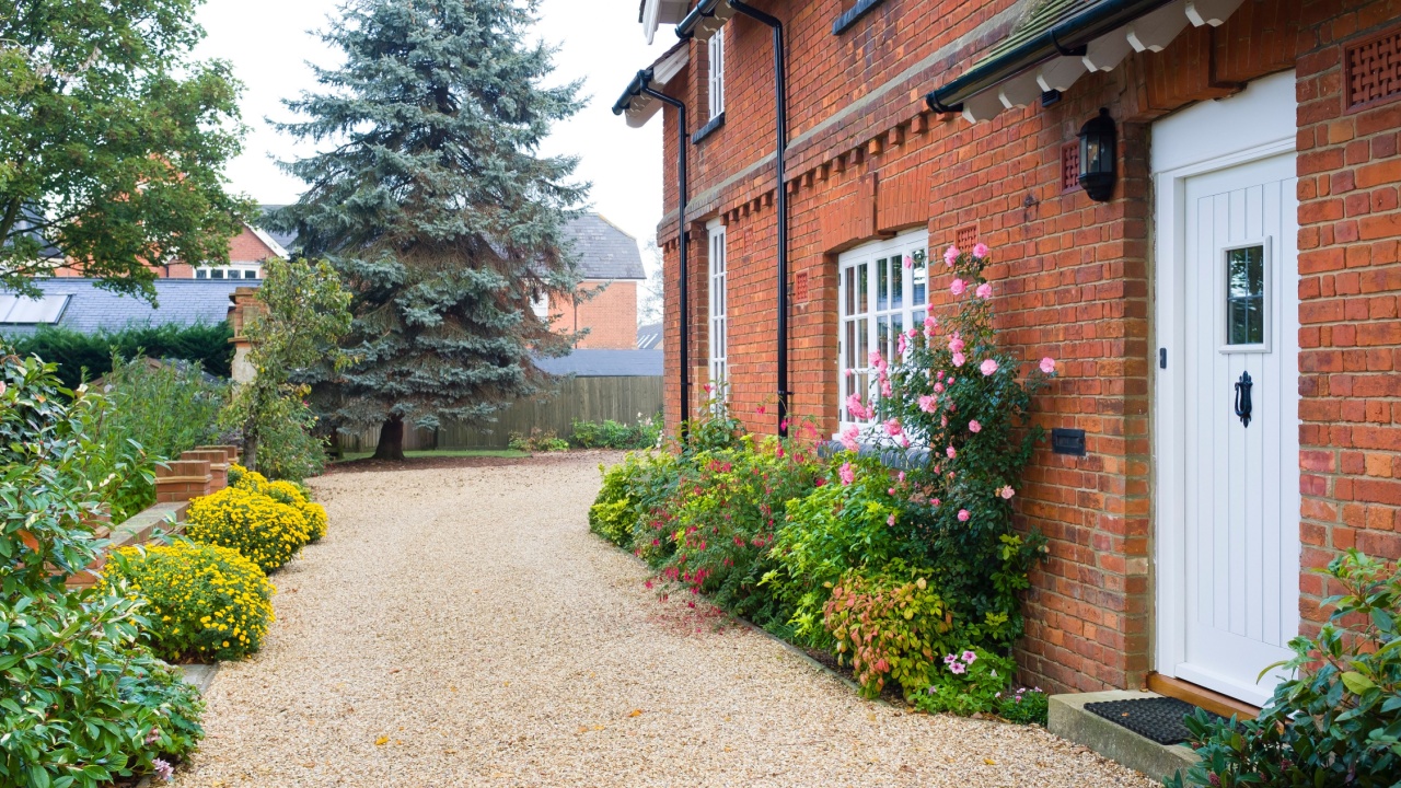 English country house and garden in Autumn with a gravel driveway