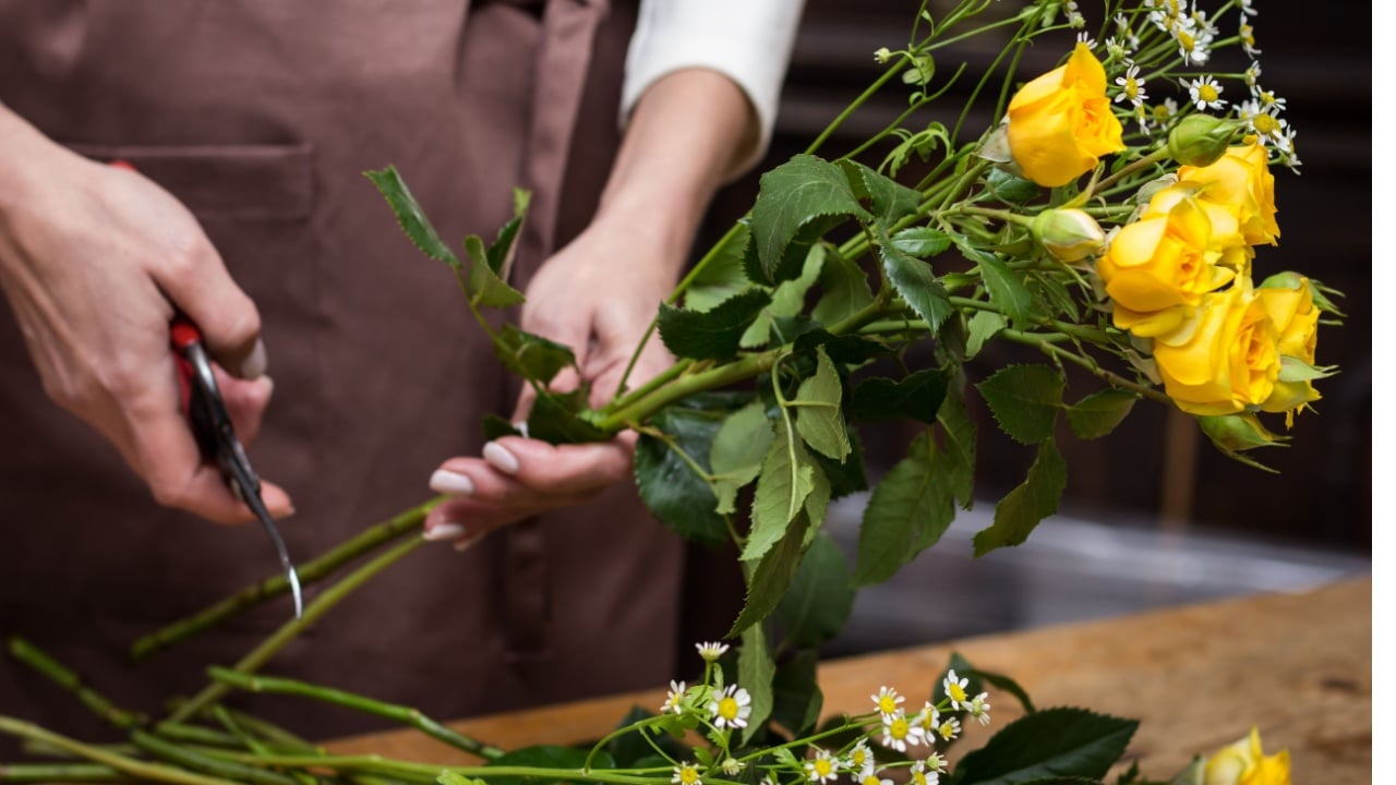 Girl florist makes bouquet