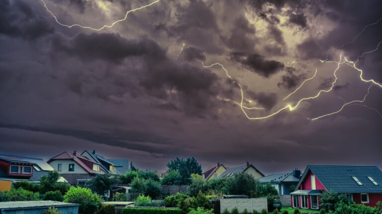 Scary lightning over houses at night during a strong thunderstorm in Deutschland