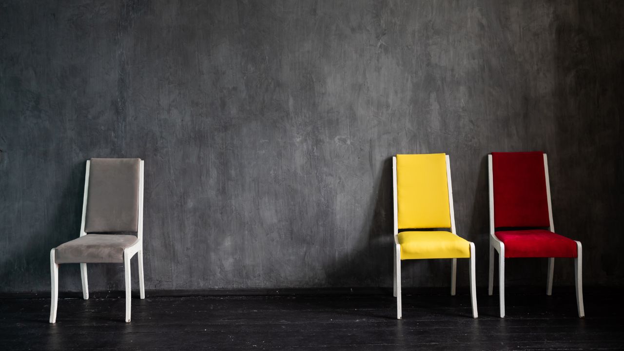 Chairs grey yellow red on black background in a dark room interior furniture